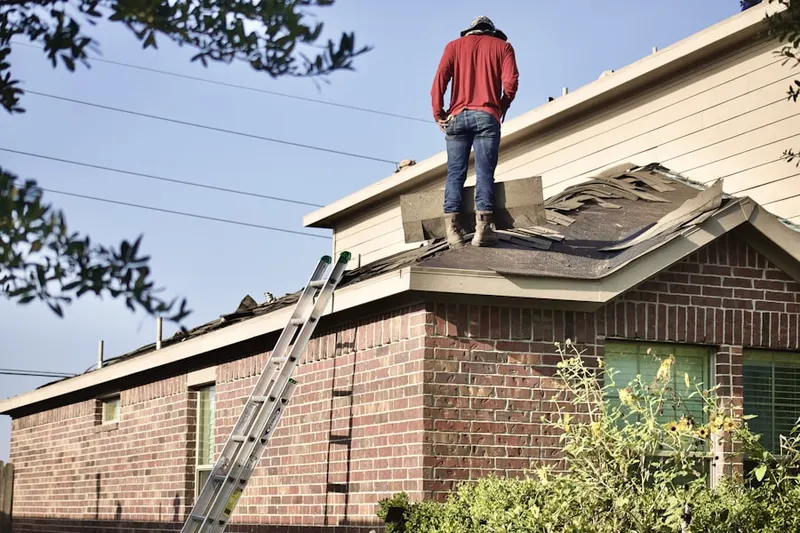 Professional roofer working on a residential roof in Carteret
